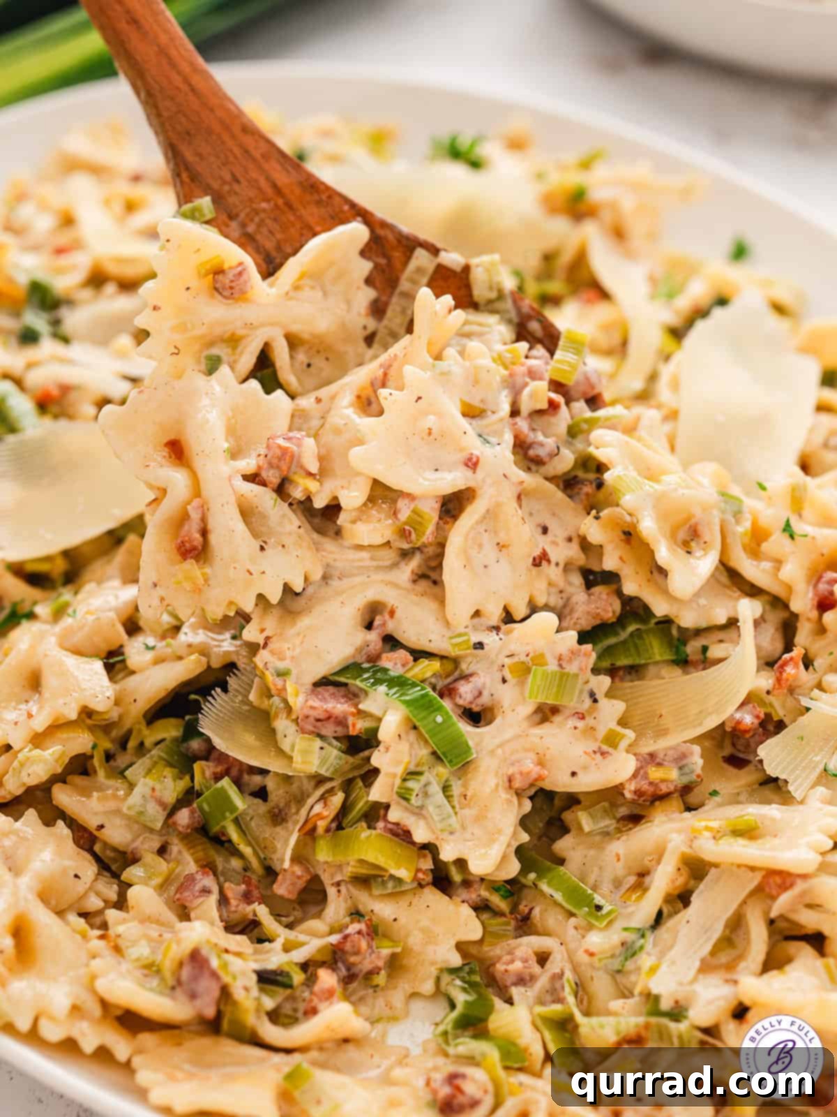 close up creamy bowtie pasta with leeks