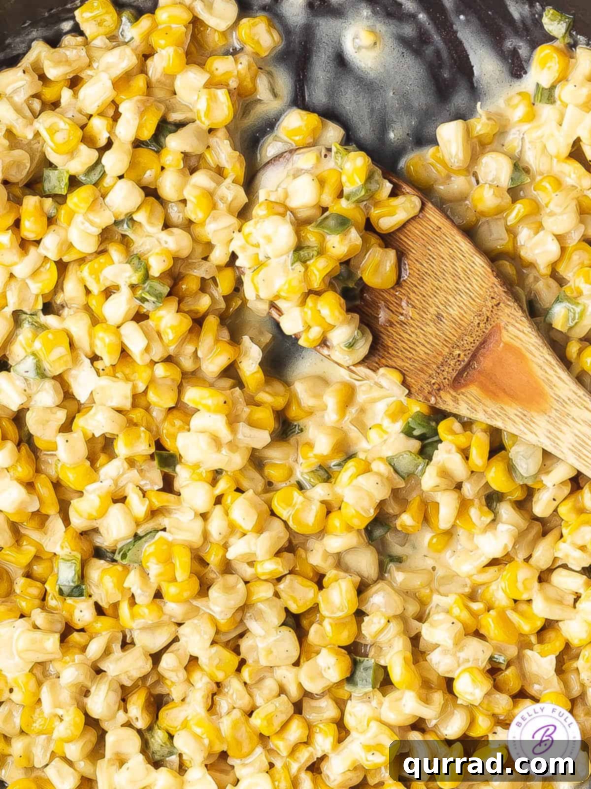 Honey Butter Kissed Skillet Corn 5 close up honey butter skillet corn with wooden serving spoon