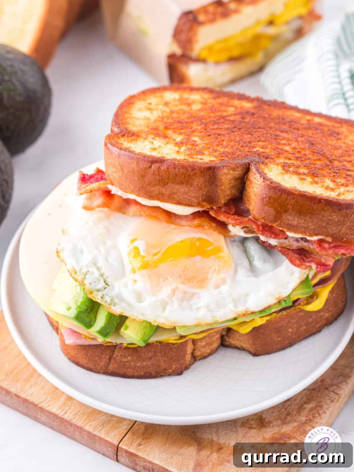 BEACH Sandwich: Stacked with Flavor Angled view of a perfectly constructed BEACH sandwich, showing off its generous and colorful layers of ingredients.