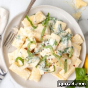 overhead Lemon Ricotta Pasta with fresh julienned basil on plate with fork