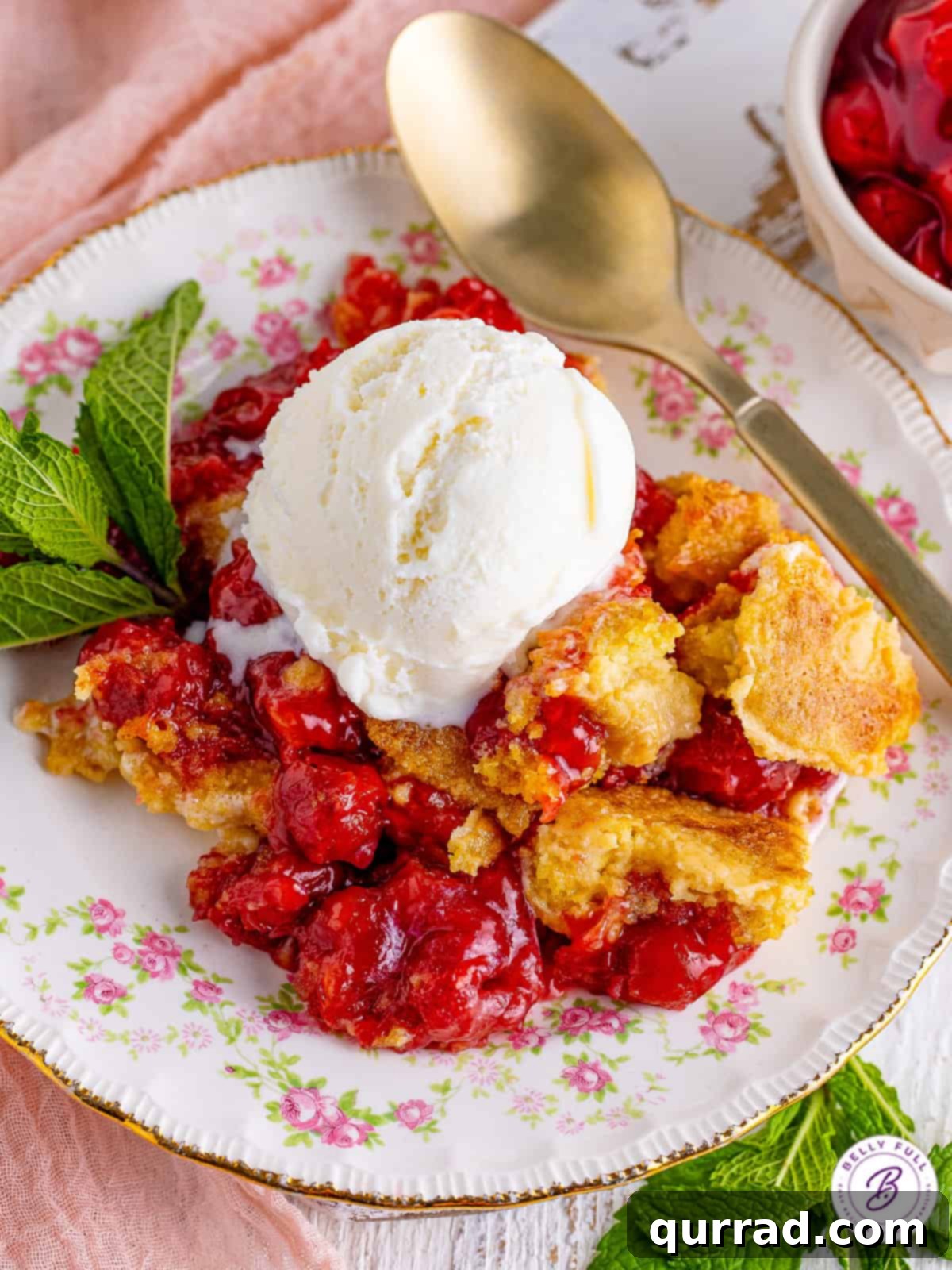 Easy Cherry Dump Cake: 5 Ingredients, 5 Minutes Prep, Crazy Delicious! A warm slice of cherry dump cake topped with a scoop of melting vanilla ice cream, garnished with a single maraschino cherry.