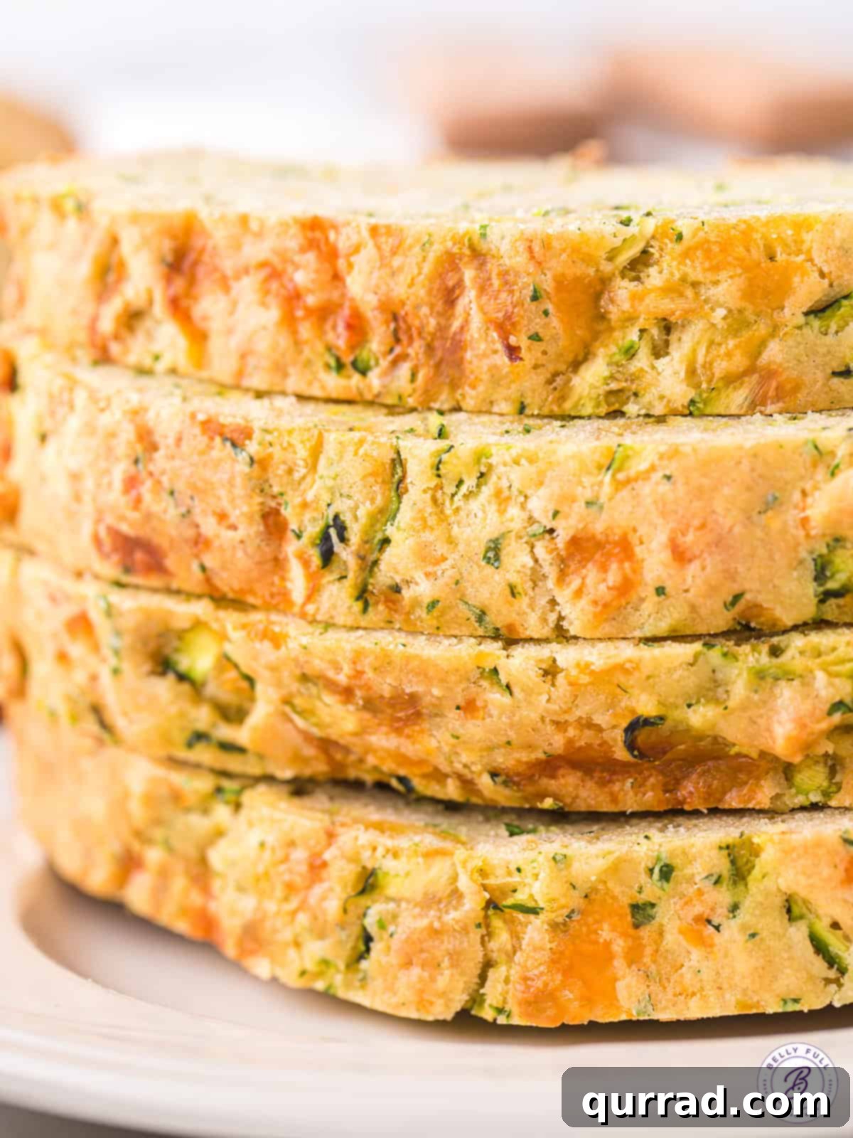 Front view of 4 zucchini cheese bread slices.