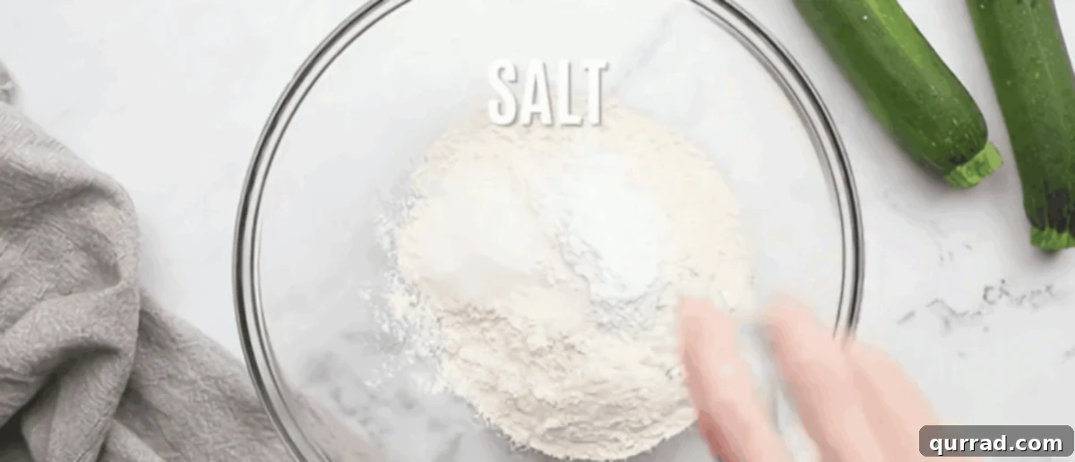 Combining dry ingredients for zucchini cheese bread.