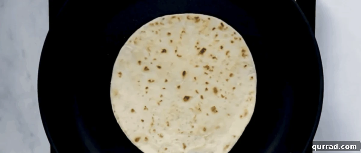 Heating tortillas in a skillet. 