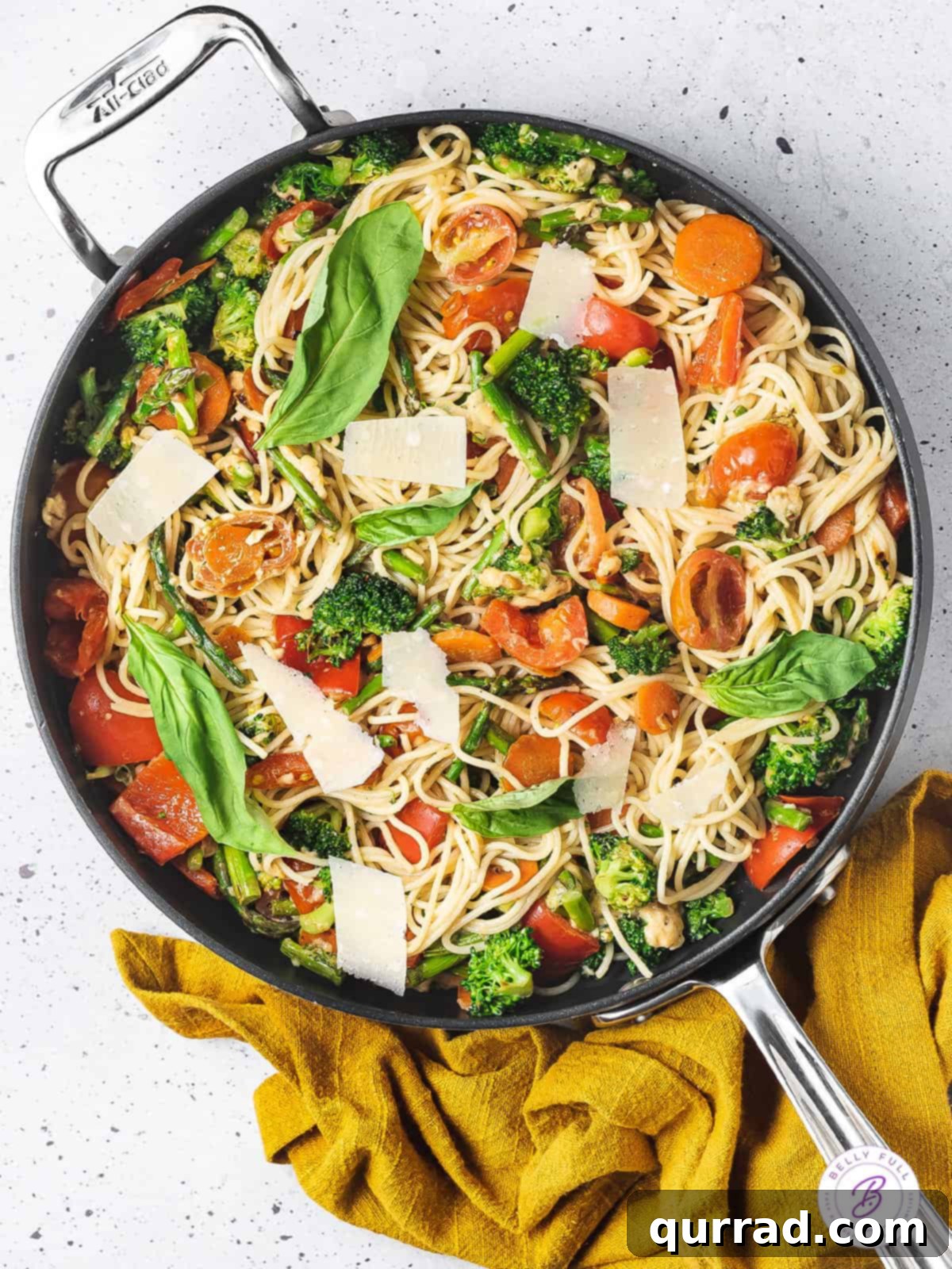Loaded with fresh veggies like broccoli and asparagus and a lemon cream sauce, Pasta Primavera is a quick and easy dinner recipe. Overhead view of pasta primavera simmering in a large skillet, ready to be served.