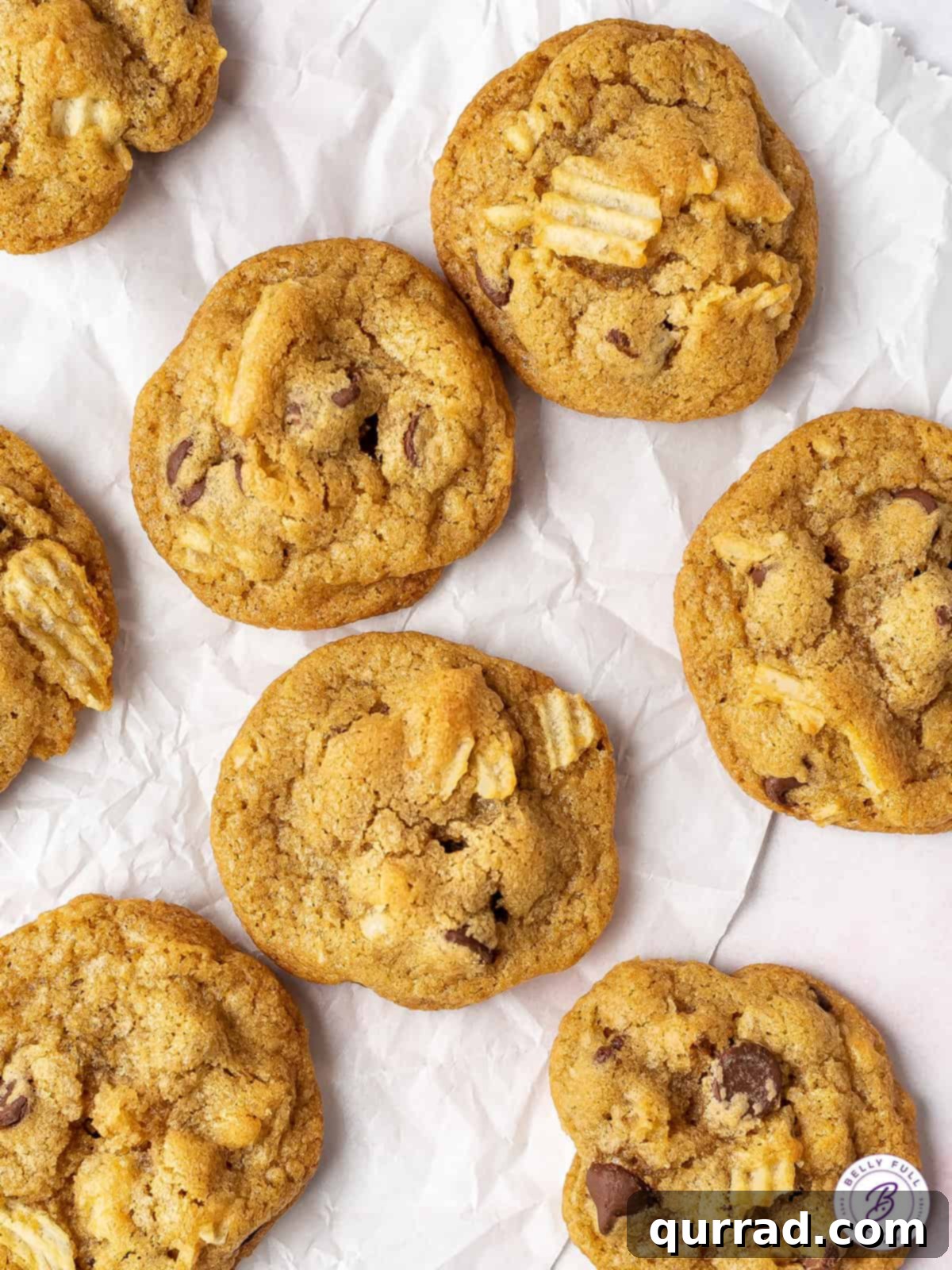 Loaded with semi-sweet chocolate chips and crunchy pieces of chips, these Potato Chip Cookies are exactly what you didn't know you need! Overhead view of chocolate chip cookies with potato chips, showcasing their delightful texture and ingredients.