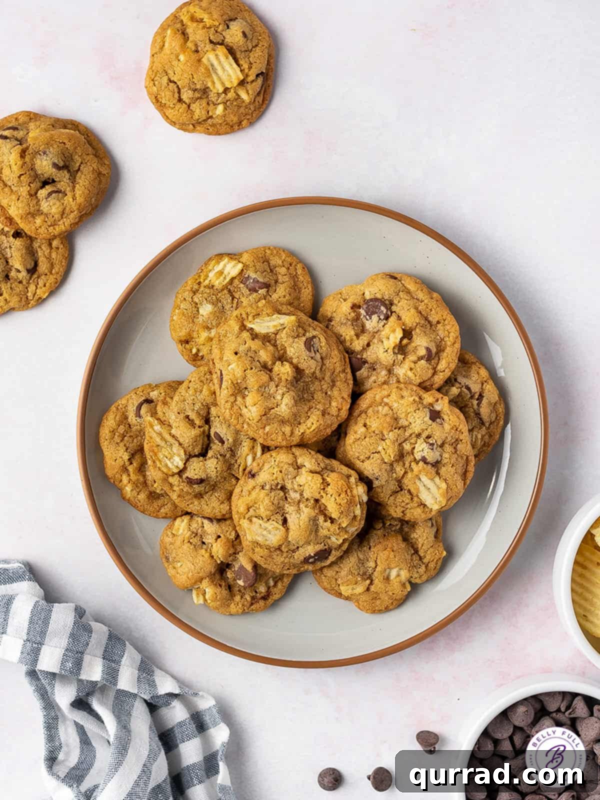 Loaded with semi-sweet chocolate chips and crunchy pieces of chips, these Potato Chip Cookies are exactly what you didn't know you need! Overhead view of a plate of perfectly baked potato chip chocolate chip cookies, ready to be enjoyed.