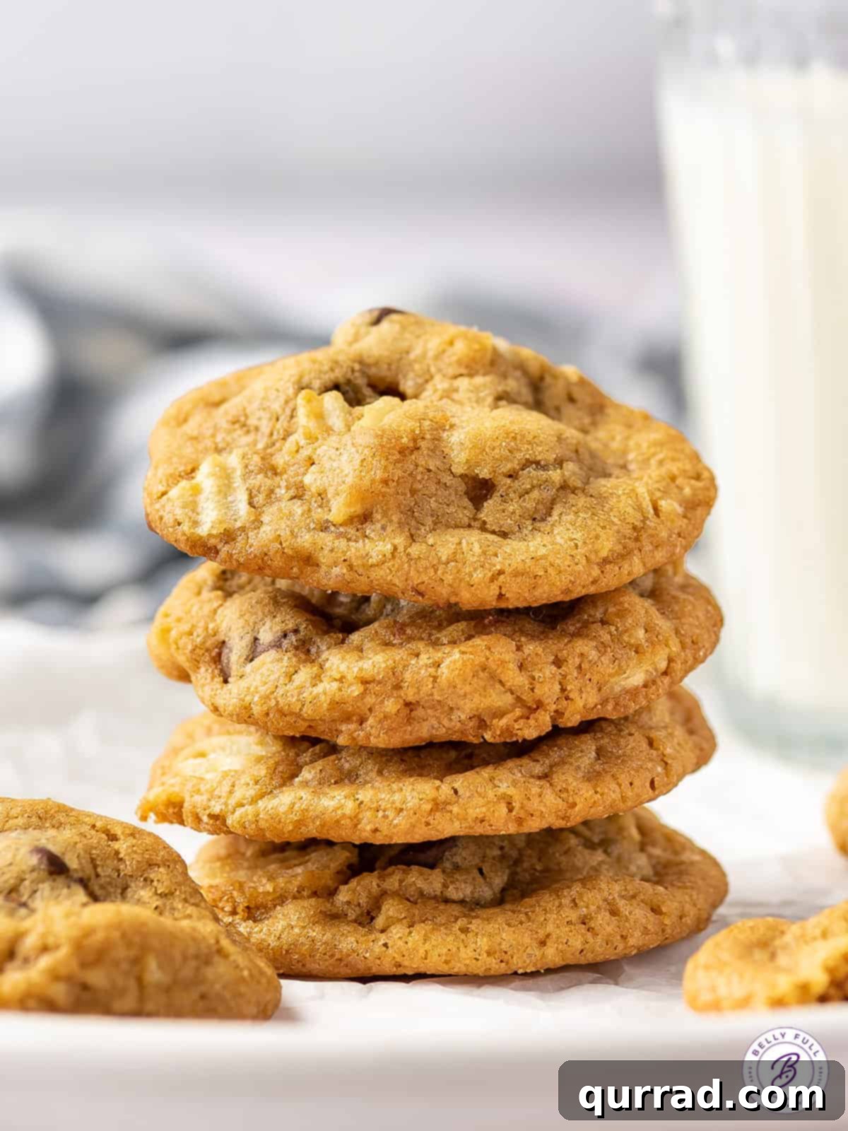 Loaded with semi-sweet chocolate chips and crunchy pieces of chips, these Potato Chip Cookies are exactly what you didn't know you need! A stack of golden brown potato chip cookies, revealing their crispy texture and delicious additions.