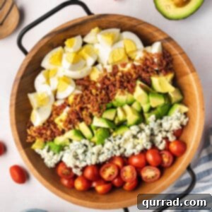 beautiful rows of cobb egg salad in wooden serving dish