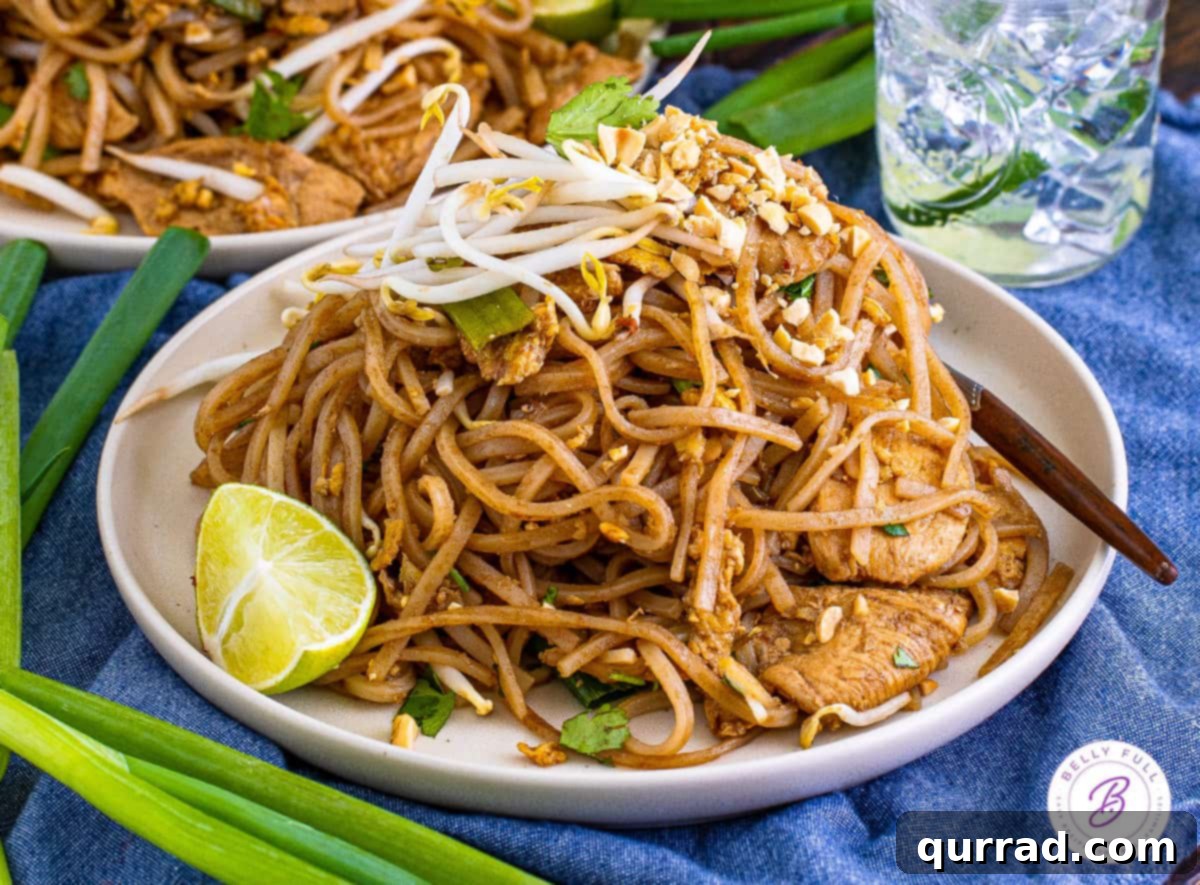 Made with authentic ingredients, this Chicken Pad Thai is better than anything you'll find at a restaurant. Ready in 45 minutes! A heaping plate of authentic Chicken Pad Thai, beautifully garnished and ready to be served.