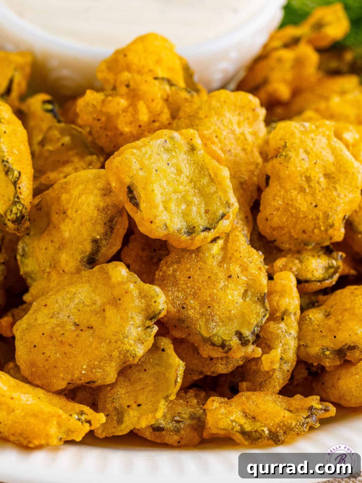 A Mountain of Crispy Fried Pickles Overhead view of a generous pile of perfectly deep-fried pickles, ready for serving.