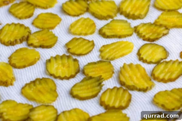 Golden Dill Bites 3 Hamburger pickle chips draining on paper towel