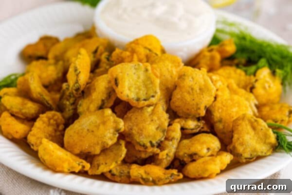 Golden Dill Bites 8 Fried pickles on plate with dipping sauce