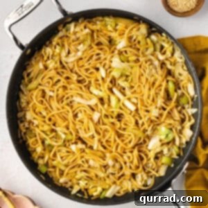 Overhead view of a big pan of chow mein, freshly cooked and steaming.