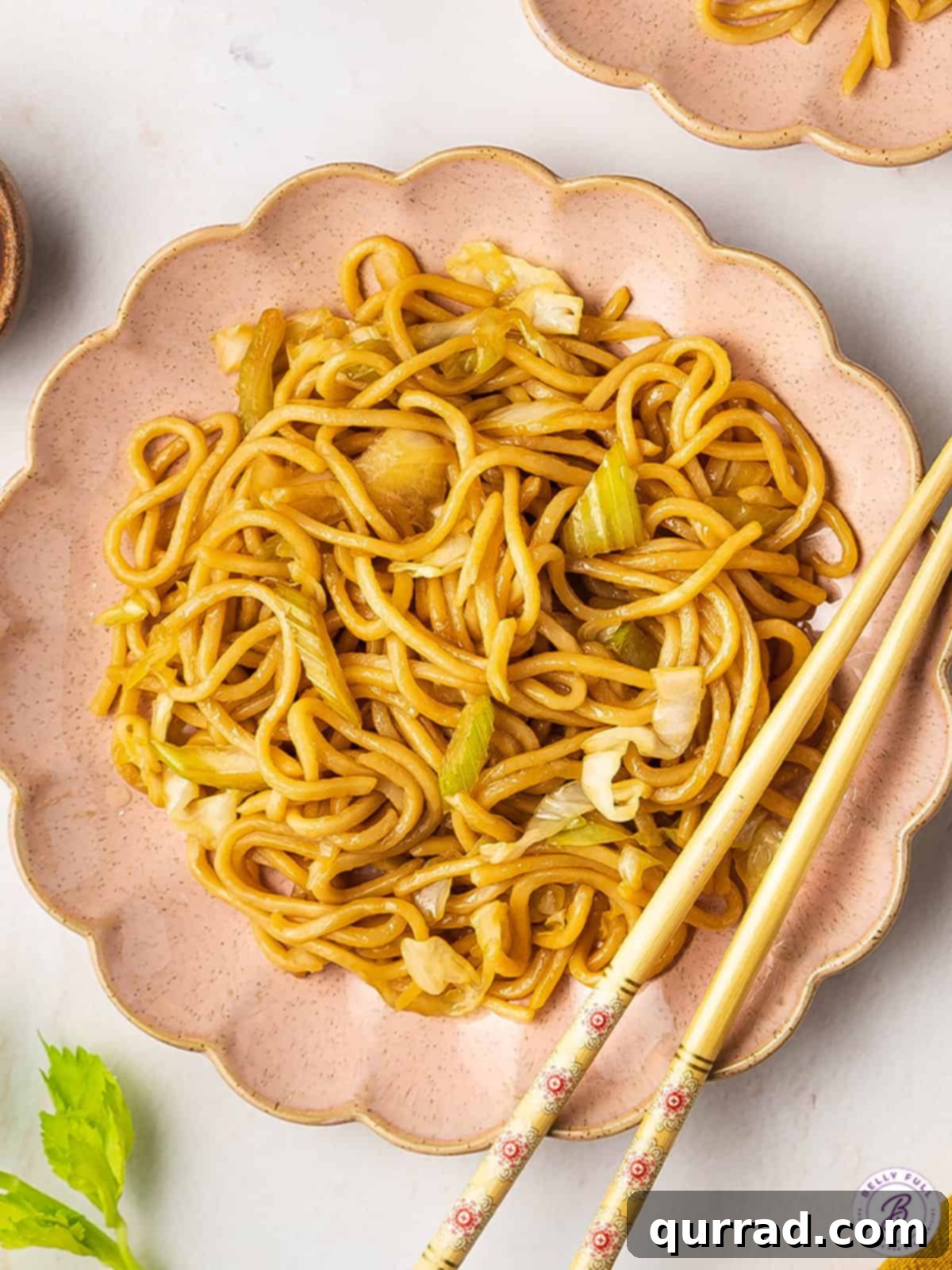 This copycat Panda Express Chow Mein recipe comes together in as little as 20 minutes! Enjoy with your other carryout favorites. Overhead view of a plate of chow mein with chopsticks, ready to be enjoyed.
