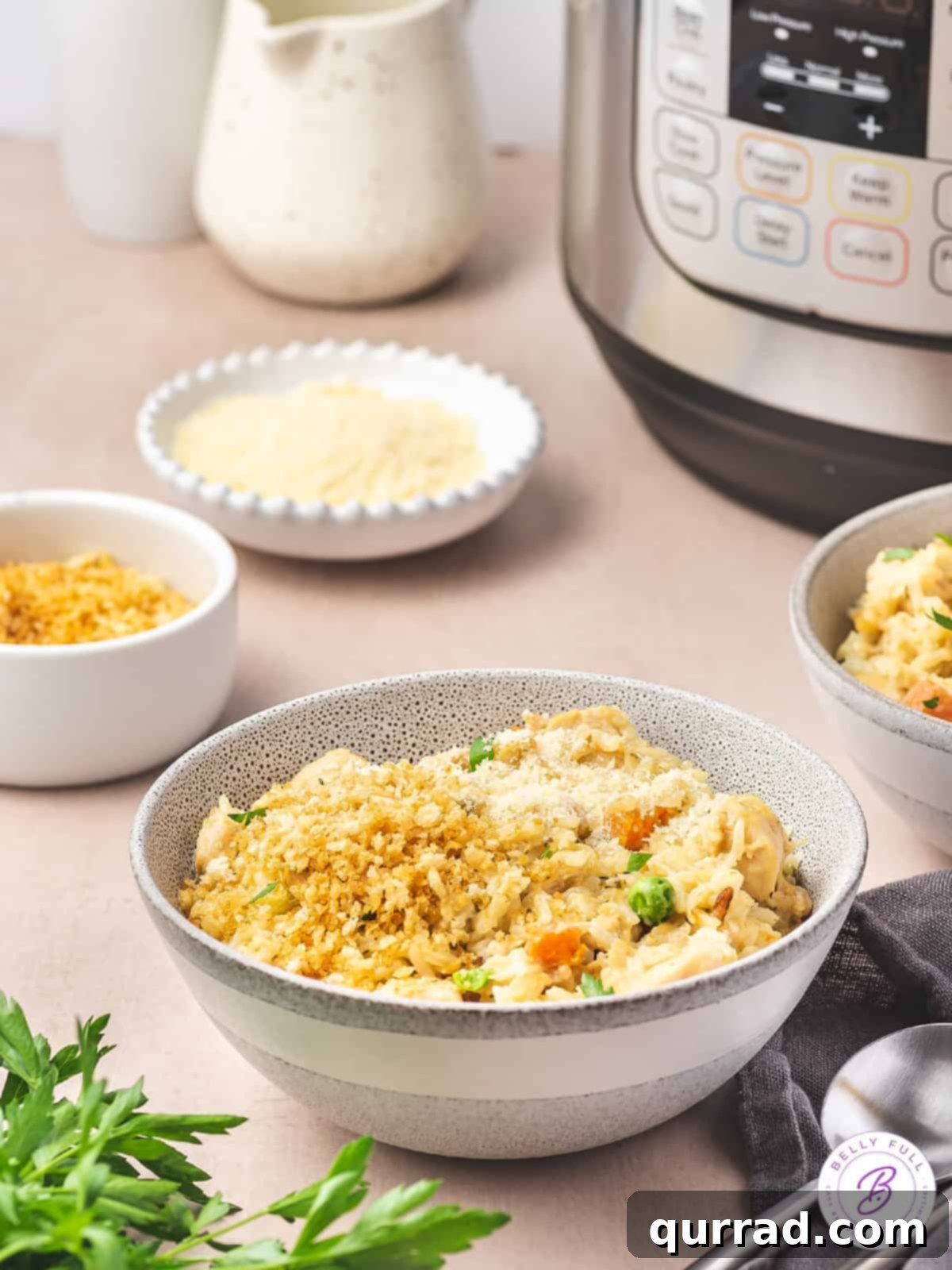 A bowl of chicken and rice with an instant pot in the background