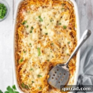 Overhead view of spaghetti casserole, showing the cheesy top layer