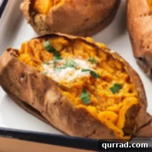 Baked sweet potatoes with butter and parsley on a sheet tray