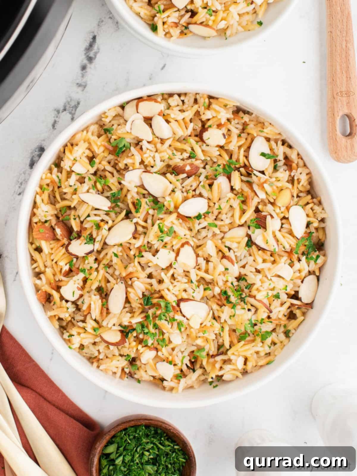 This Instant Pot Rice Pilaf comes out perfectly each time, with a rich, nutty flavor and lovely crunch from the sliced almonds. Overhead view of a big bowl of Instant Pot rice pilaf