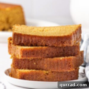 Golden Nectar Delight 2 Close-up of three stacked slices of honey cake, showing a golden crust and tender, moist interior.