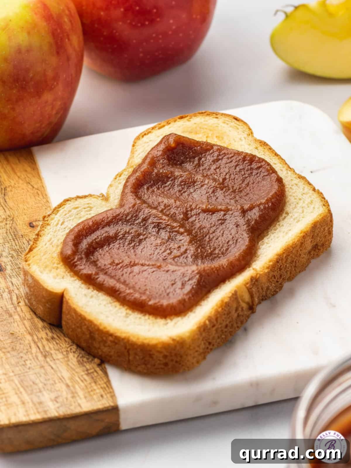 Serve this delicious Slow Cooker Apple Butter on toast, pancakes, or with biscuits. A perfectly toasted slice of bread generously topped with smooth, homemade slow cooker apple butter, ready to be enjoyed as a comforting treat.