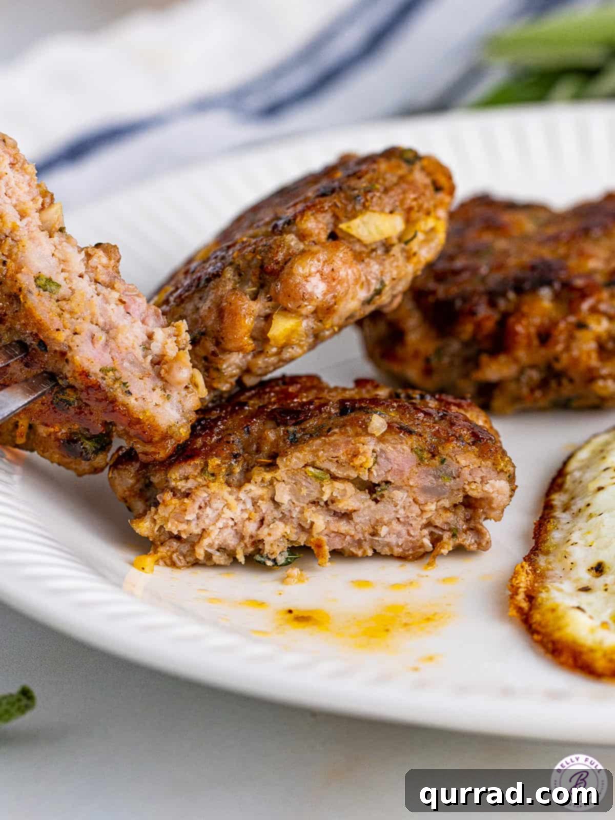 Homemade breakfast sausage patties cut in half on a plate