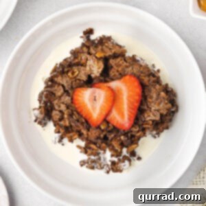 A plate of brownie baked oatmeal with sliced strawberries