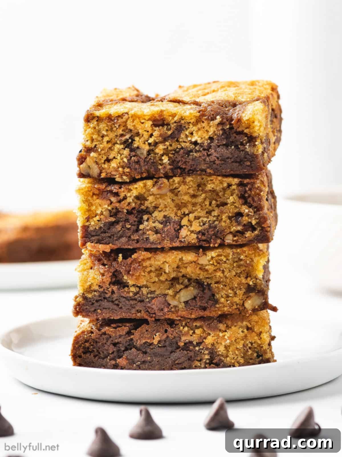 Fudgy brownies topped with chewy chocolate chip cookies, these Brookies are made completely from scratch in under an hour. A stack of 4 chocolate chip cookie brownie bars, showcasing their distinct layers of fudgy brownie and chewy chocolate chip cookie.