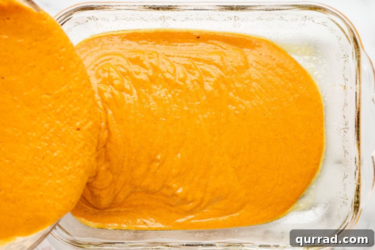 Golden Pumpkin Spice Streusel Bake 5 The smoothly whisked pumpkin mixture poured into a greased 9x13 inch baking pan, forming the base layer of the dump cake.