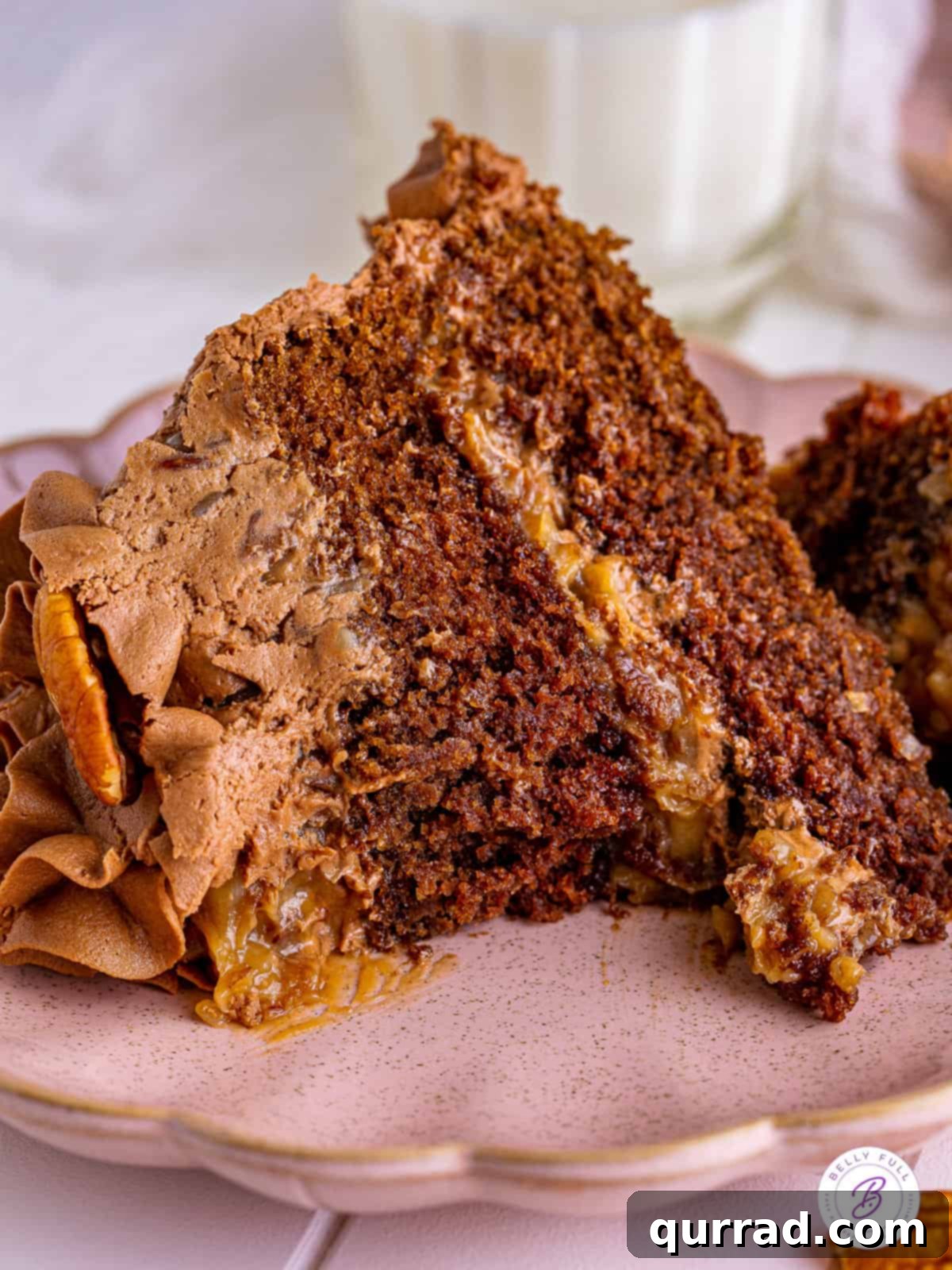 A delicious slice of German Chocolate Cake with a bite taken, highlighting its tender texture. A slice of German chocolate cake with a small bite missing, showing off the fluffy cake and rich frosting.