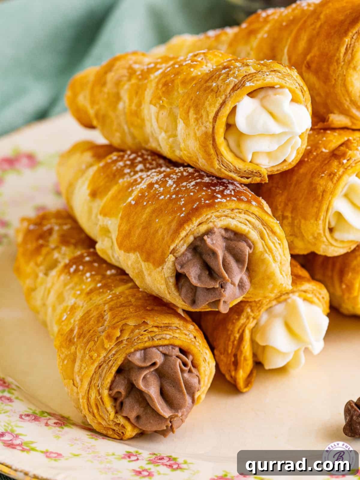 Chocolate and vanilla cream horns stacked on each other, showing the variety of fillings.