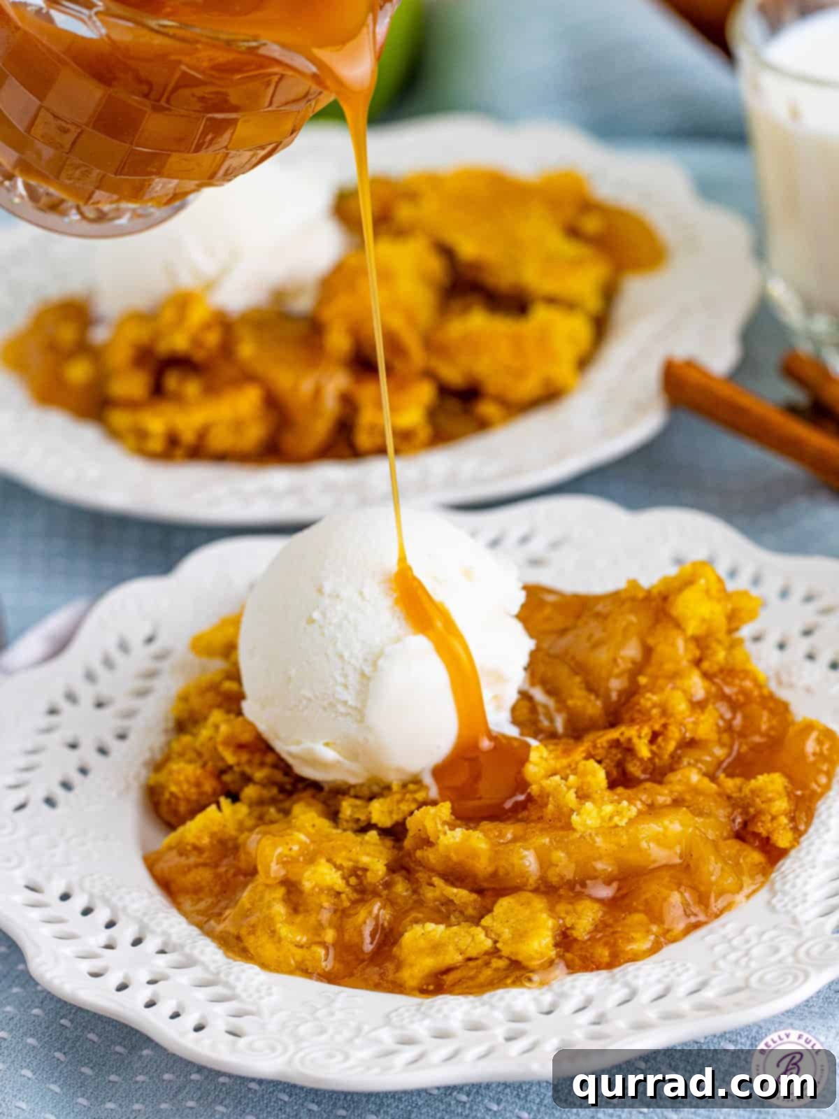 Irresistible Caramel Apple Dump Cake 9 Rich caramel sauce being drizzled over a warm slice of caramel apple dump cake and a scoop of vanilla ice cream, creating a decadent finish.