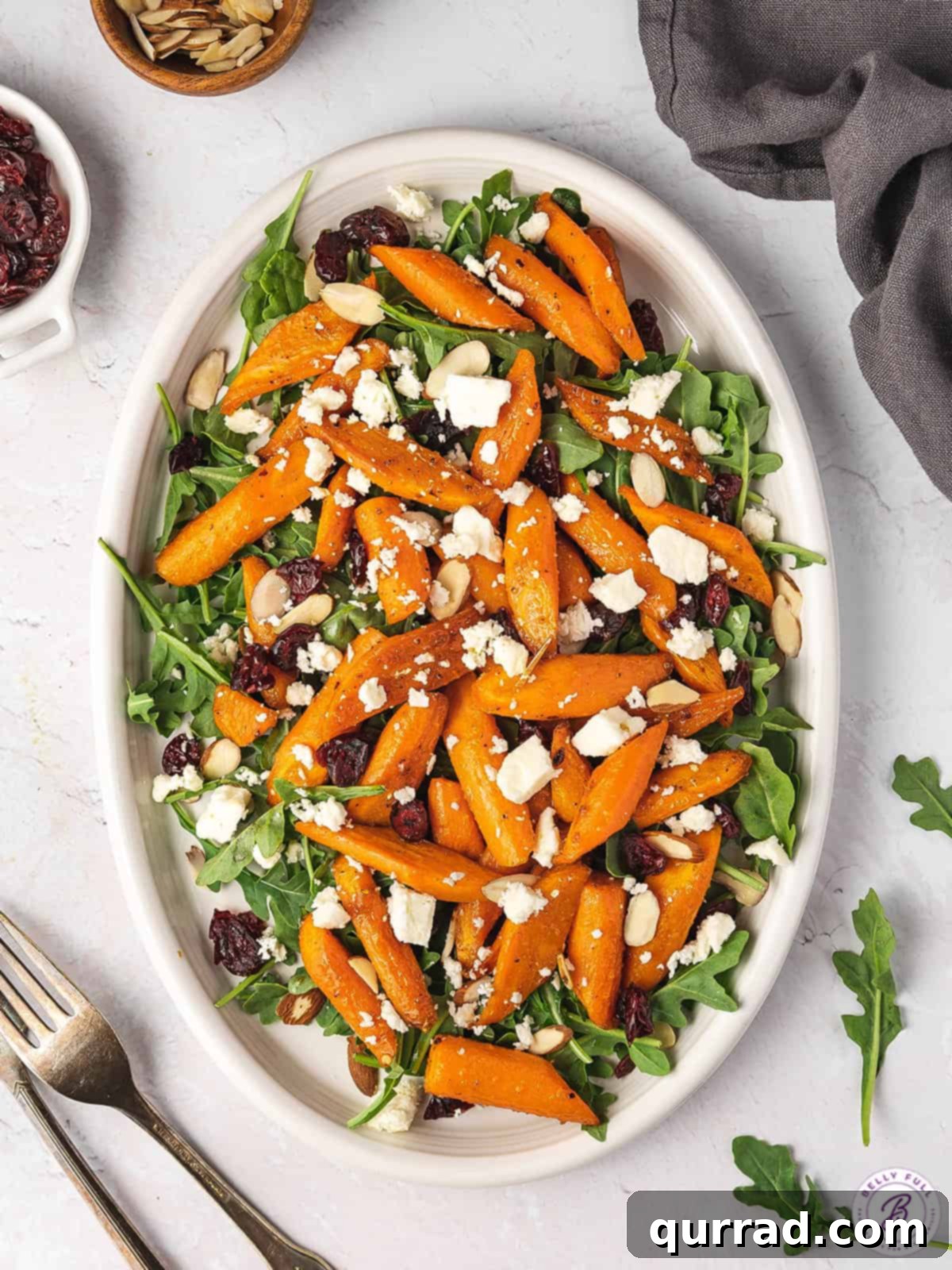Overhead view of a winter salad with carrots on a white platter