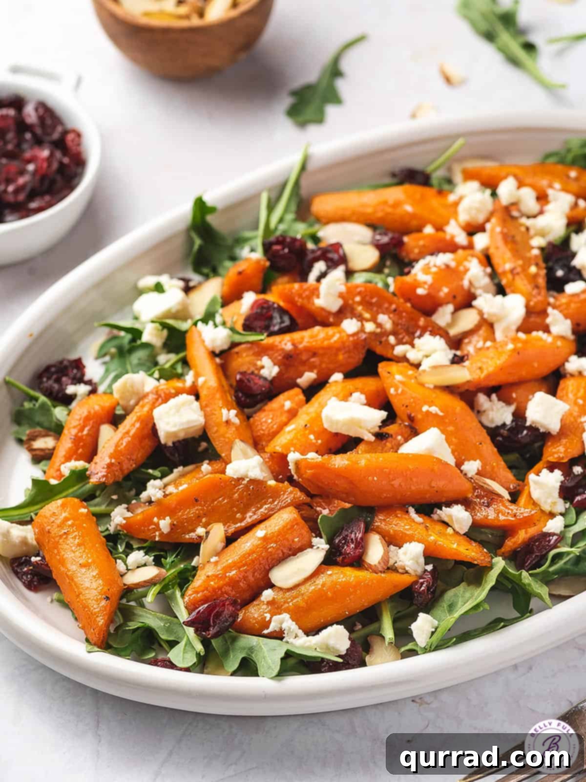 Angled view of a serving platter of roasted carrot salad