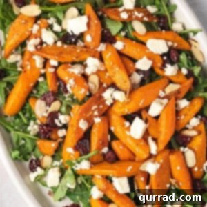 Overhead view of roasted carrot salad on a white platter