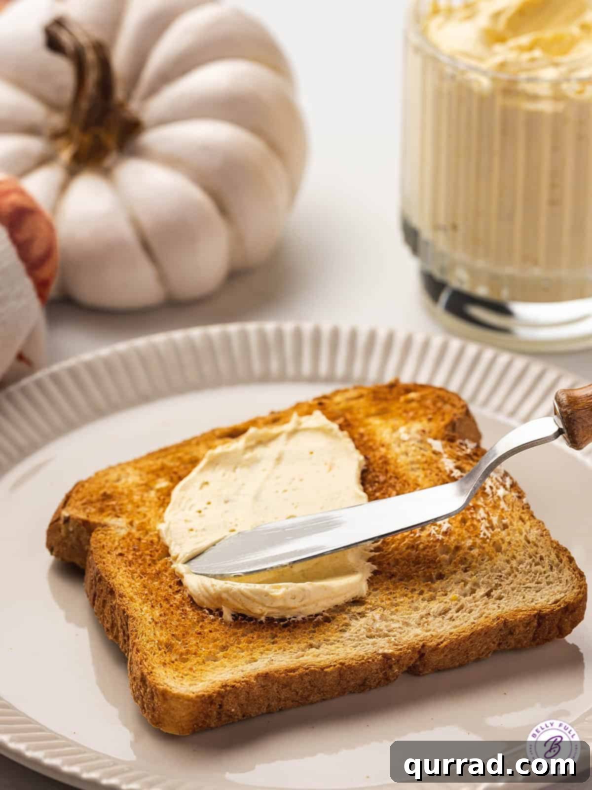 Fluffy Spiced Pumpkin Butter 3 knife spreading pumpkin butter on toast