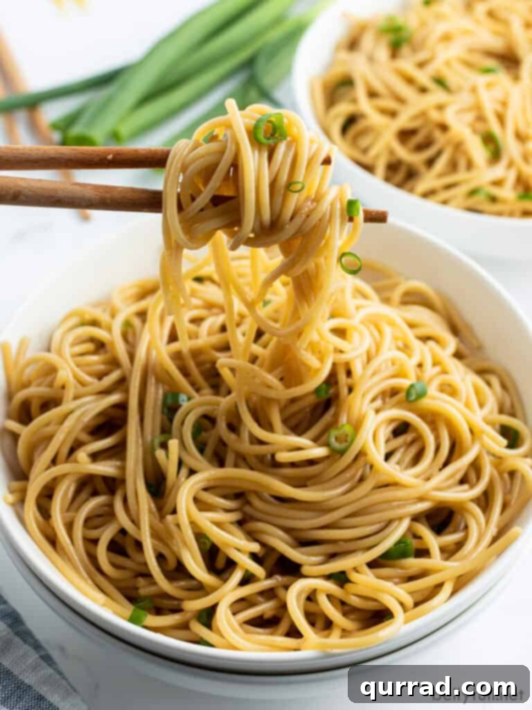 Simply Delicious Sesame Noodles 4 sesame noodles hanging from chopsticks, showing texture