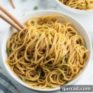 sesame noodles in bowl with chopsticks