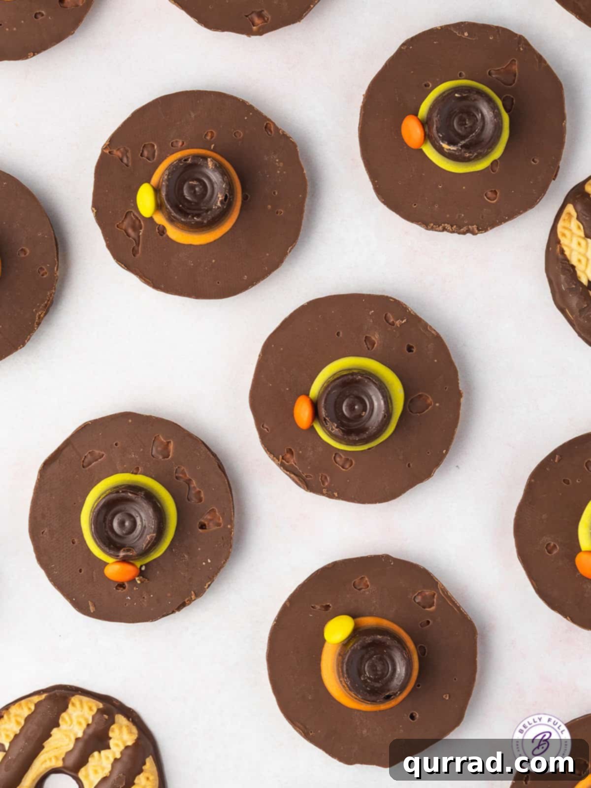 Overhead view of Pilgrim Hat Cookies being assembled, showing the striped cookie base and Rolo candy.