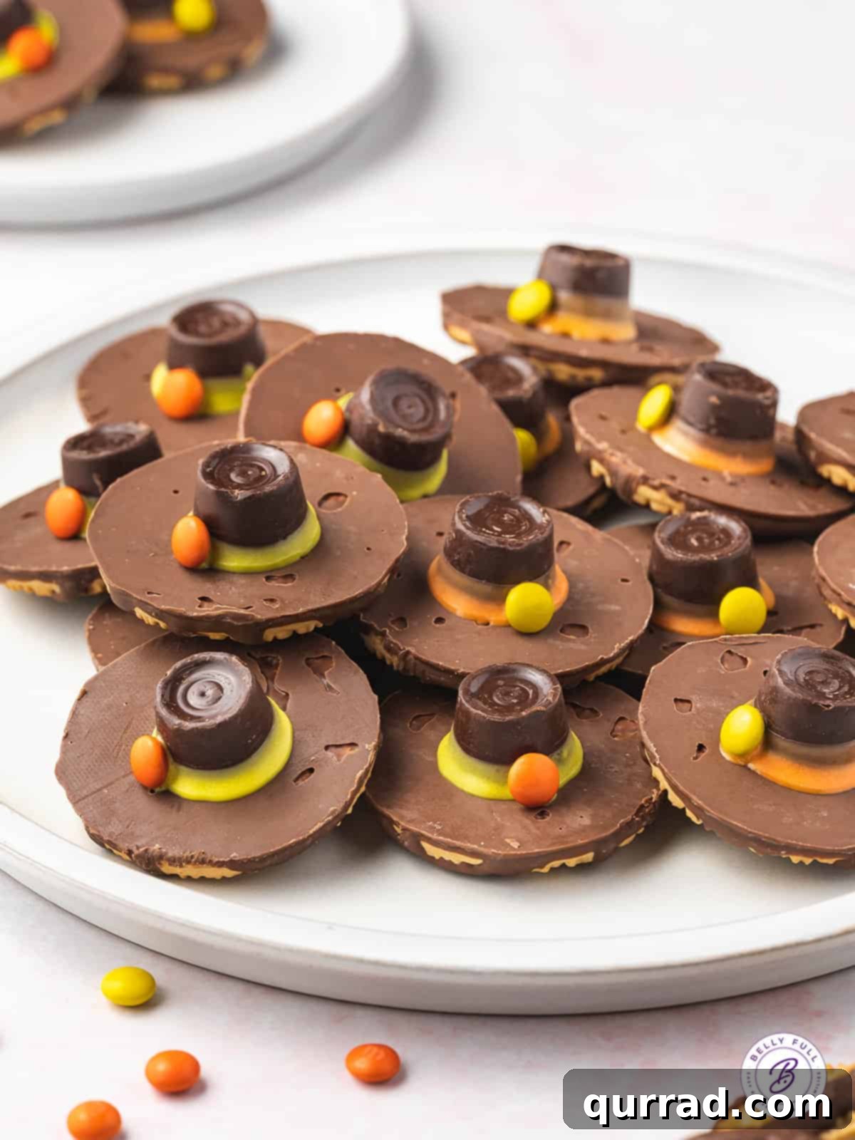 A beautifully arranged plate brimming with Thanksgiving Pilgrim Hat Cookies, ready to be served.