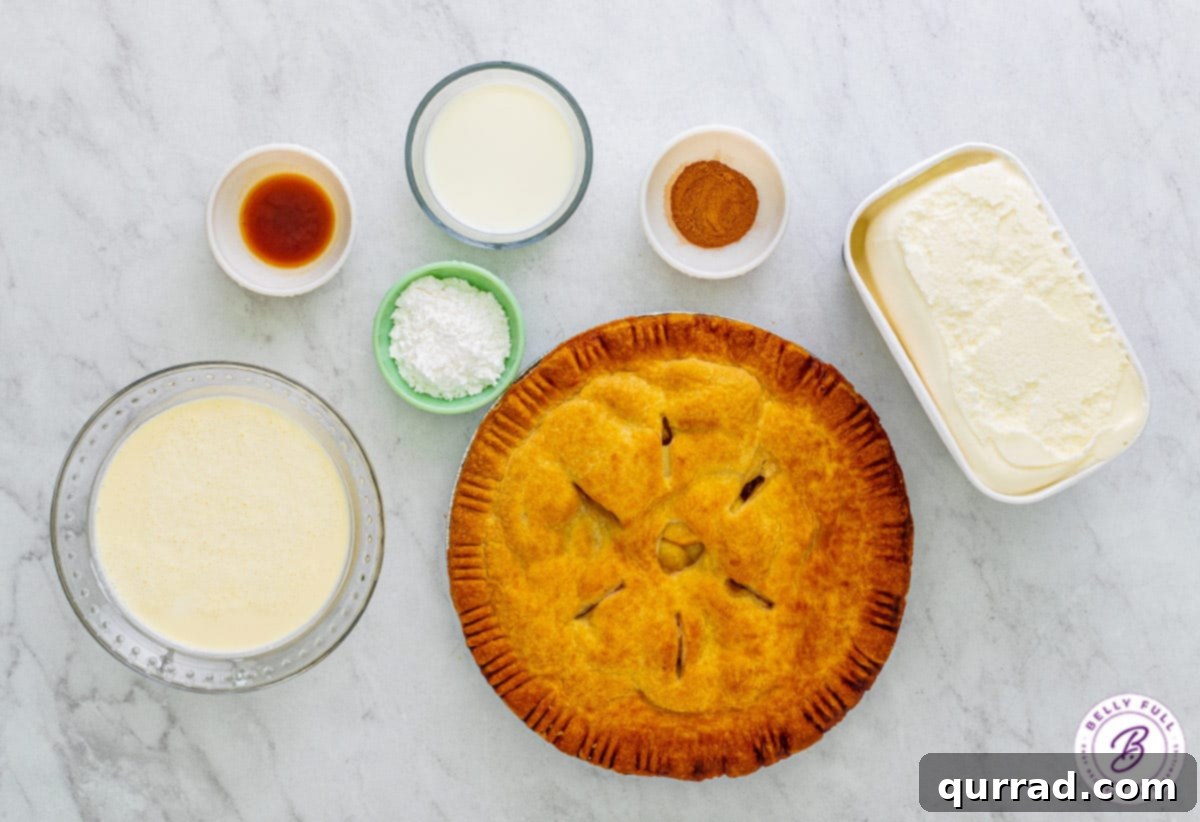 An overhead shot showcasing the key ingredients for an apple pie milkshake, including heavy cream, ice cream, whole milk, and a slice of apple pie.