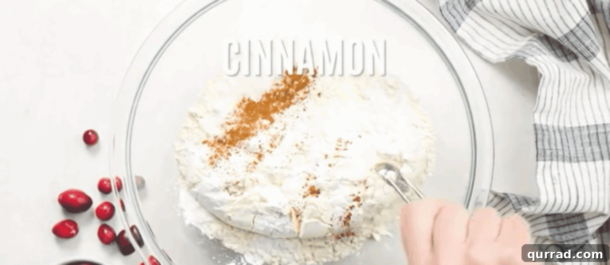Combining dry ingredients for Cranberry Bliss Bars in a mixing bowl.
