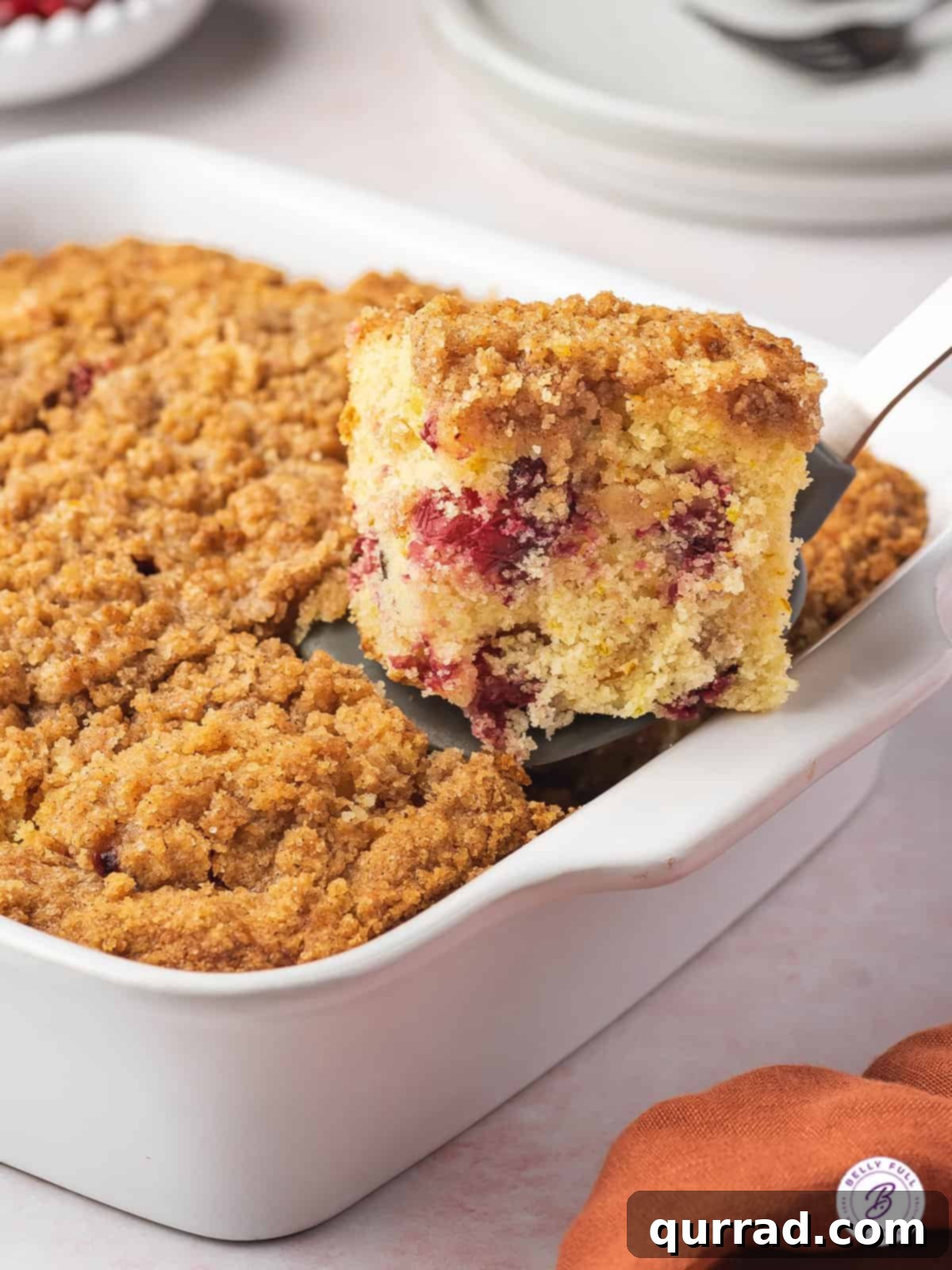 Sweet-Tart Cranberry Crumble Cake 2 piece of cranberry coffee cake on serving spatula