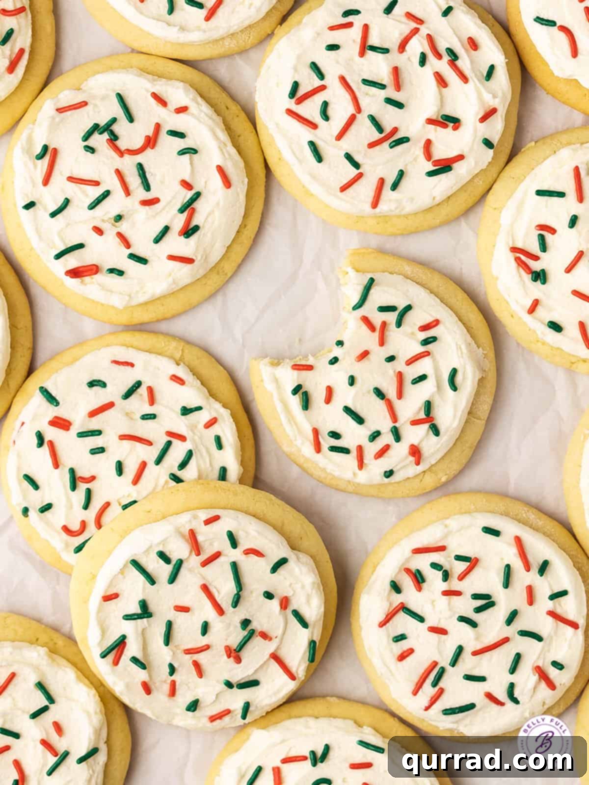 Christmas Lofthouse Cookies are the perfect copycat of soft, delicate frosted sugar cookies from the grocery store bakery. Overhead view of Lofthouse frosted sugar cookies arranged artfully.