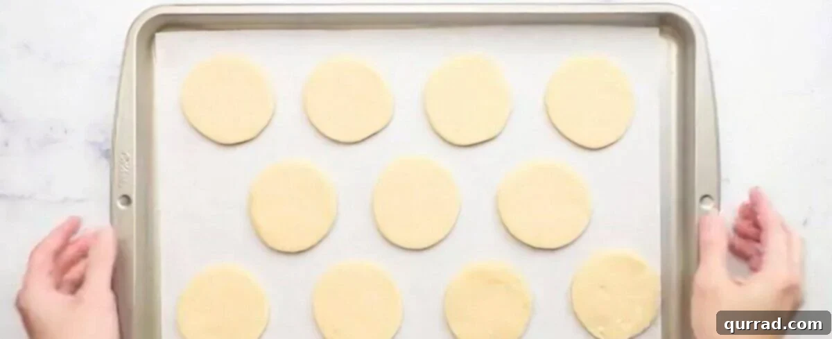 Lofthouse Inspired Soft Sugar Cookies 6 Chilled cookie dough rolled out and cut into 3" circles on a cookie sheet.