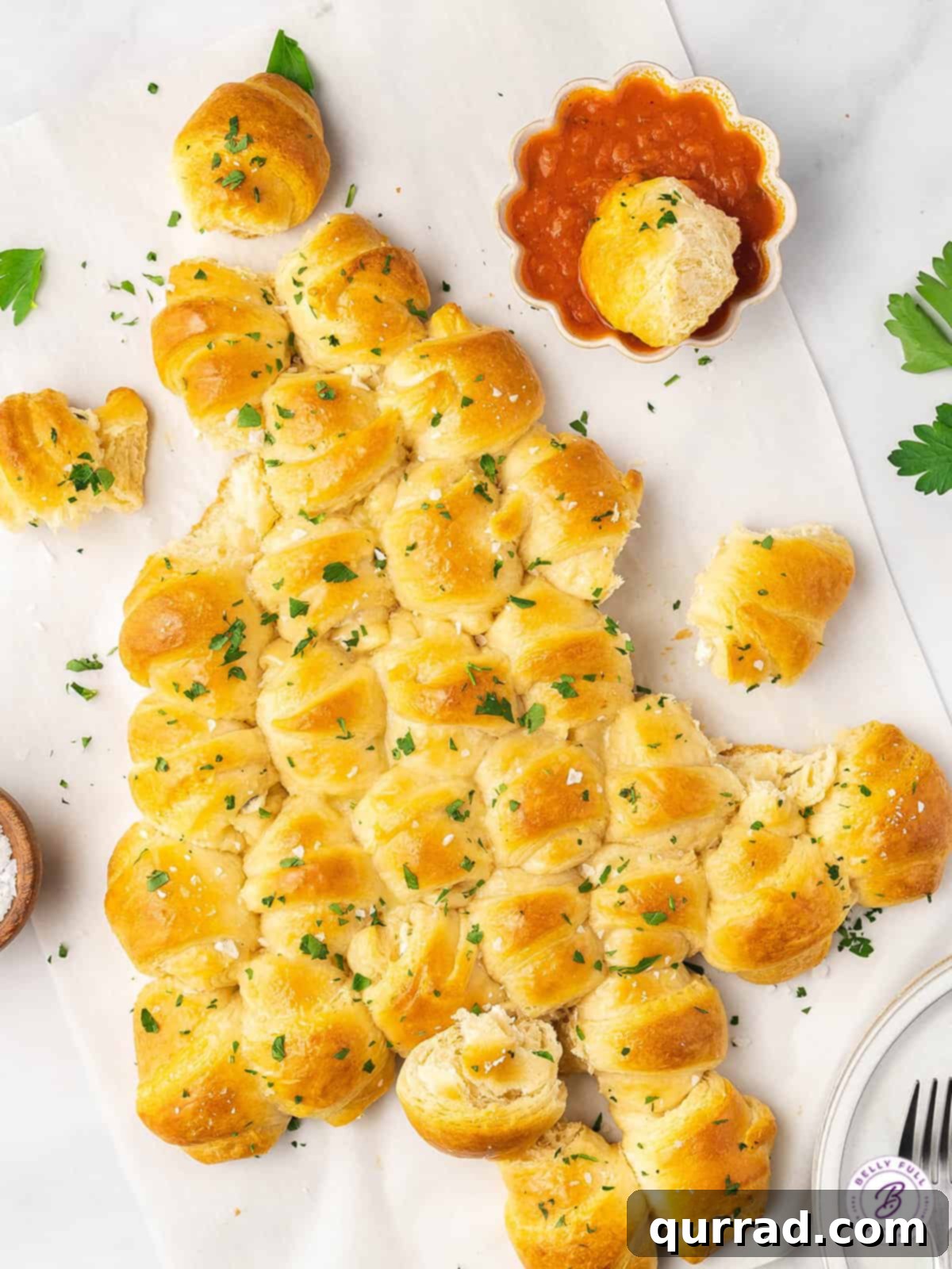 With flaky crescent rolls and herbed cream cheese, this Pull Apart Crescent Roll Christmas Tree is an easy holiday appetizer. Pull apart Christmas tree with several pieces already enjoyed, showcasing the cheesy interior