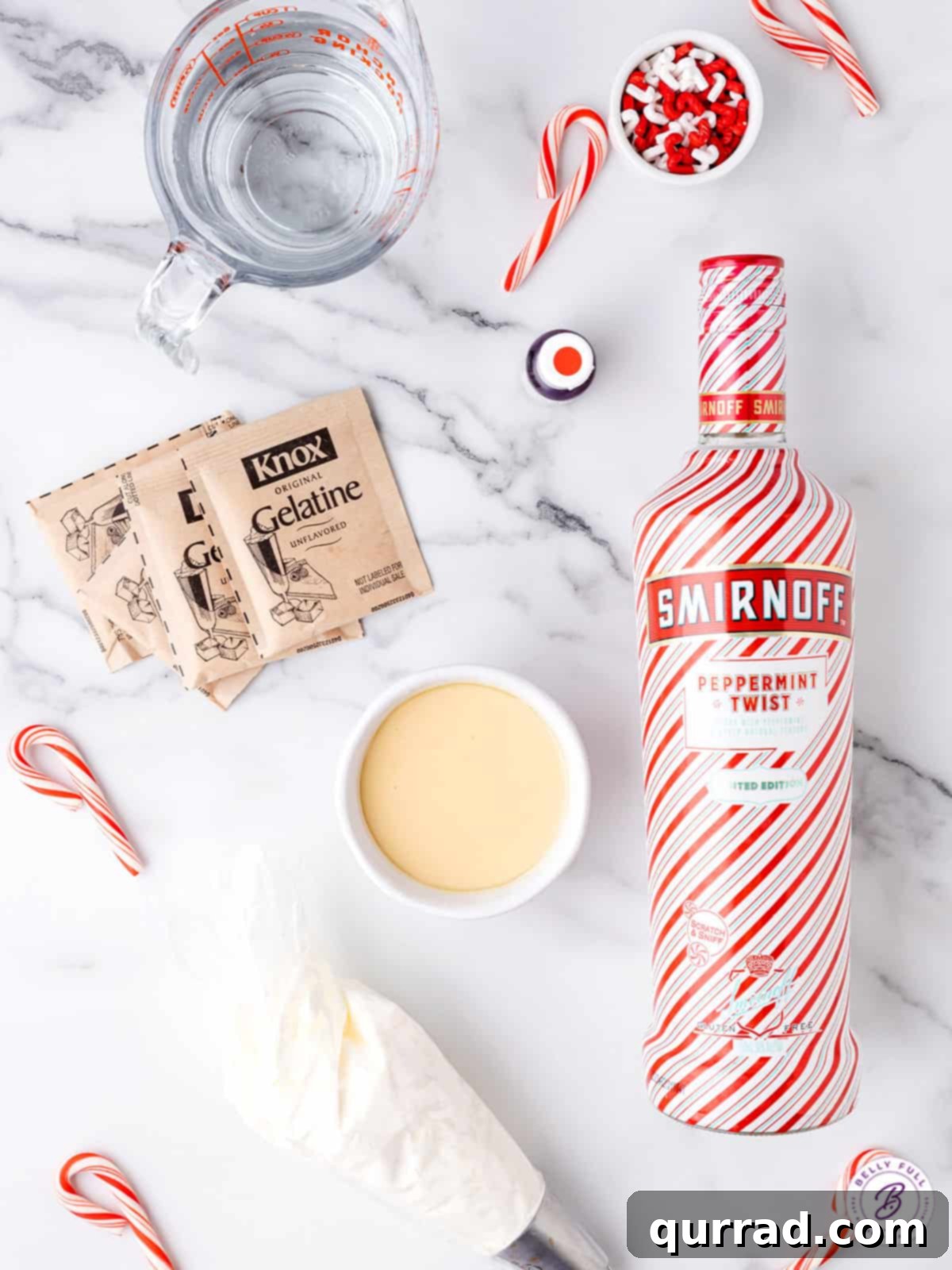 Peppermint Twist Shooters 3 An overhead view showcasing the simple ingredients needed to create delightful candy cane jello shots, including vodka, gelatin, and condensed milk.