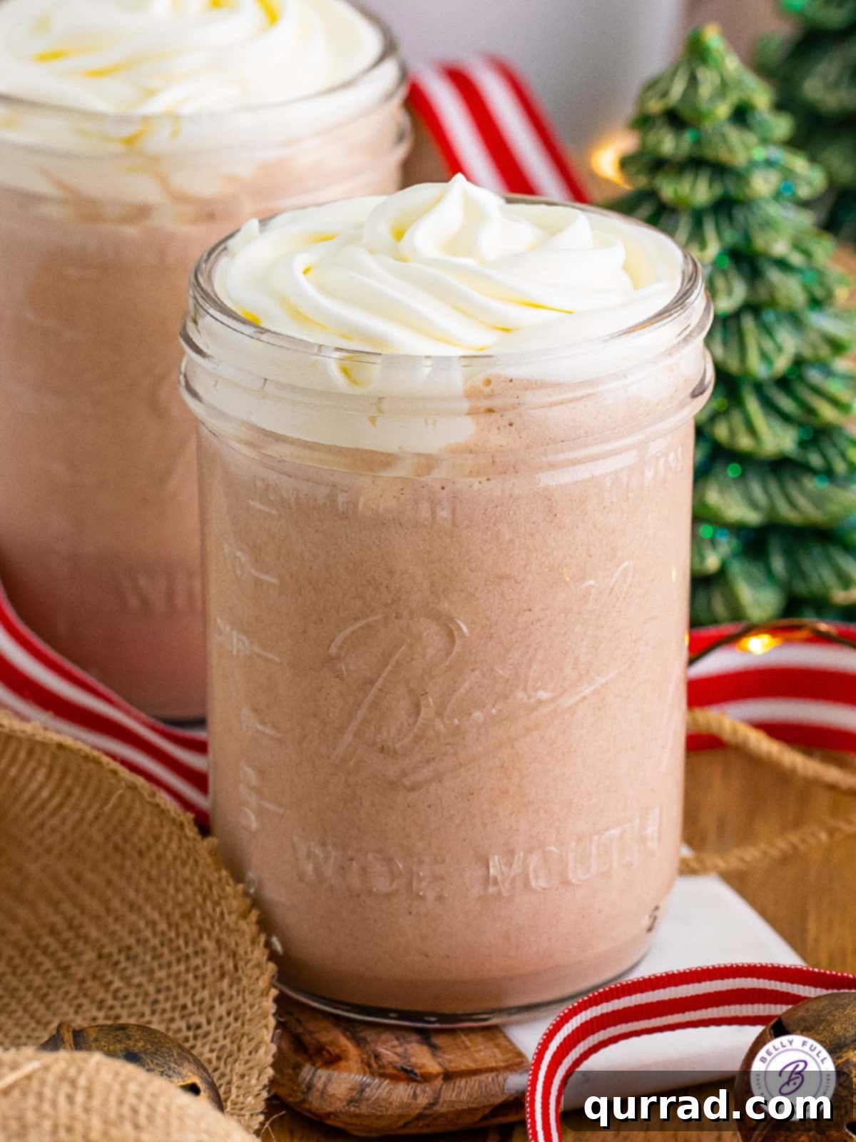 Rudolph's Red-Nosed Revelry 2 Creamy chocolate milkshake topped with whipped cream and festive garnishes, ready to be served as a Drunk Rudolph Milkshake.