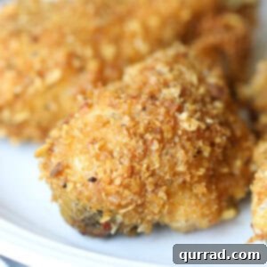 close up cornflake coated baked chicken drumstick