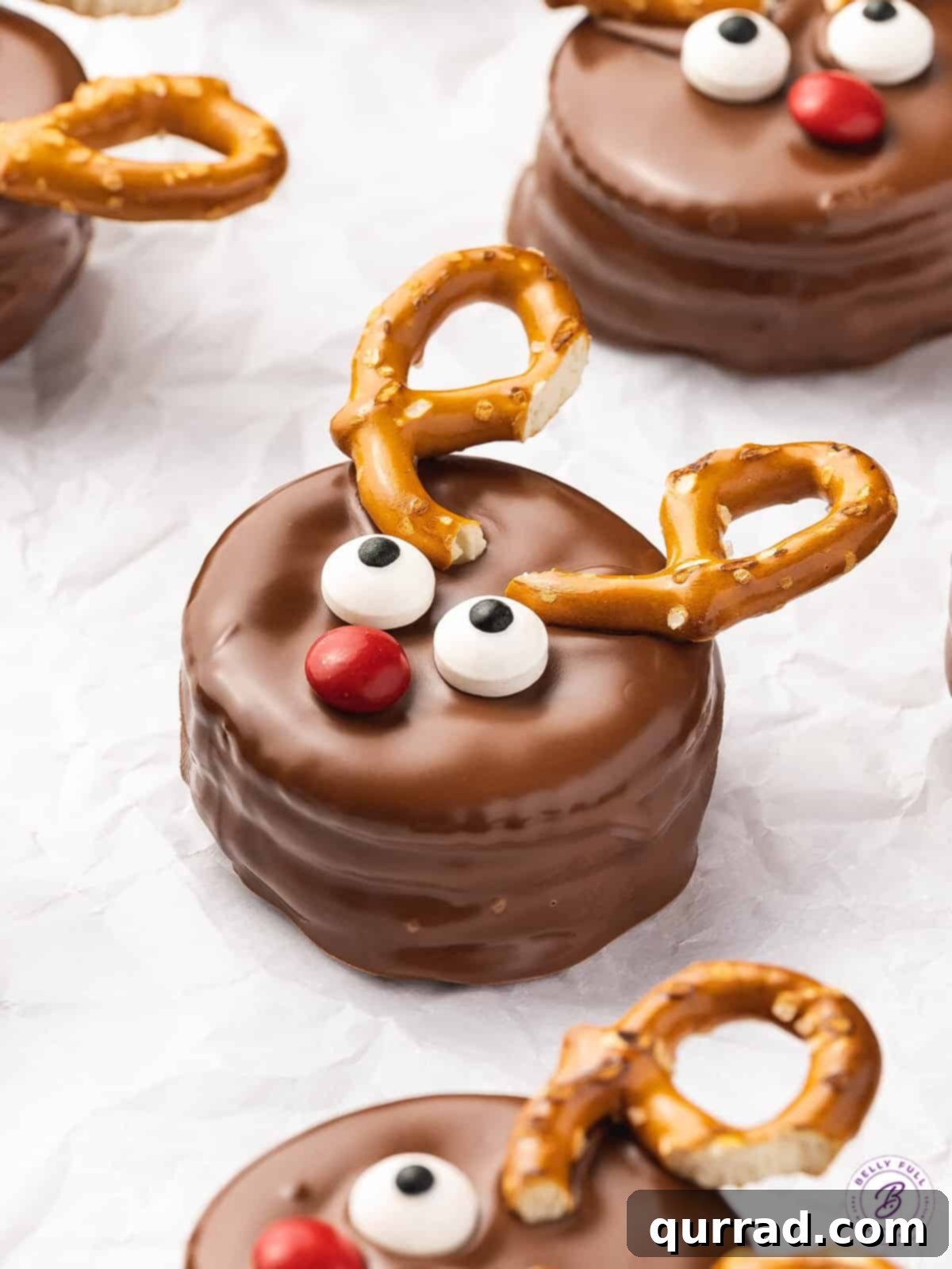 Festive Reindeer Ritz Treats 5 A festive array of Reindeer Ritz Cracker Cookies, featuring candy eyes, bright red M&M noses, and pretzel antlers, ready to be enjoyed.